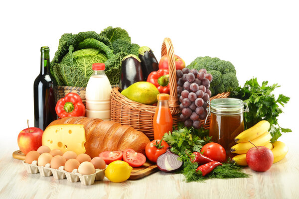 Groceries in wicker basket including vegetables and fruits
