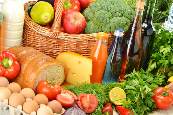 Groceries in wicker basket including vegetables and fruits
