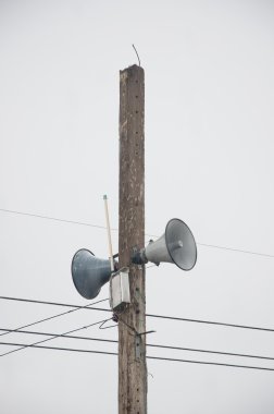 Audio speaker on electric light pole clipart