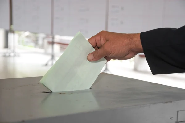 stock image Hand put voting paper