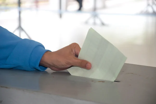 stock image Hand put voting paper