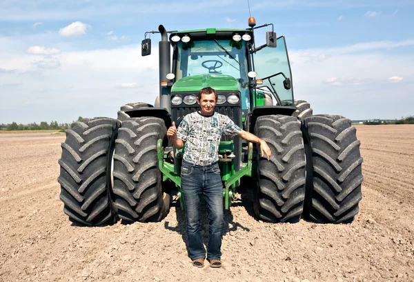 Farmer with tractor showing OK gesture — Stock Photo, Image