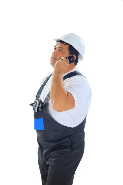 Trabalhador da construção falando no telefone isolado no fundo branco — Fotografia de Stock