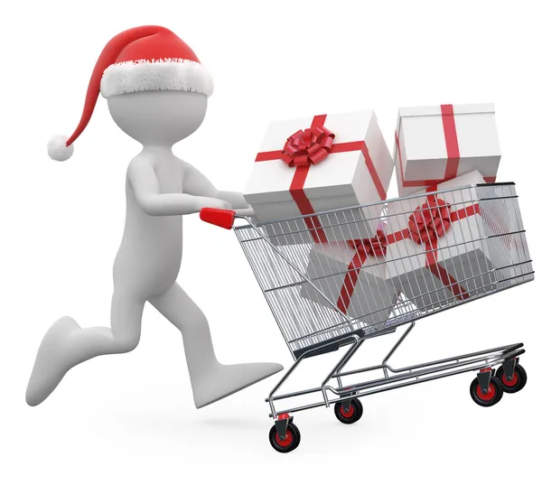 Hombre con sombrero de Santa empujando un carrito de compras lleno de regalos —  Fotos de Stock