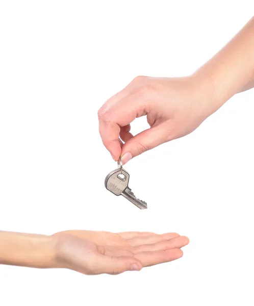Photo handing over a key female hand holding a key and handing i