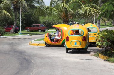 Yellow coco taxis in Varadero clipart