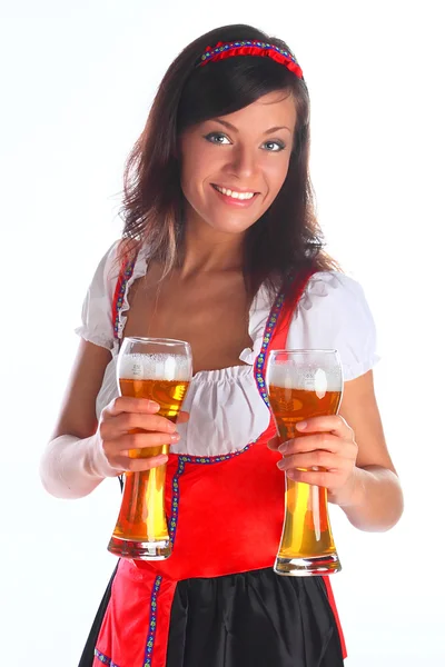 Flickan i en traditionell bayersk klänning Stockbild