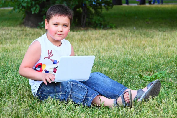 stock image The little boy with the laptop