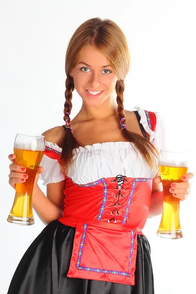 Flickan i en traditionell bayersk klänning Stockfoto