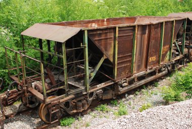 Wagons are near the plant clipart