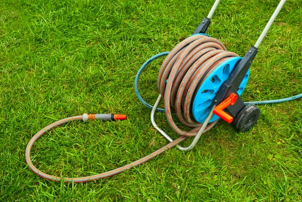 stock image Hose for watering the garden on the green grass