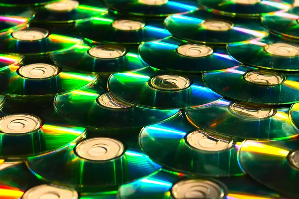 stock image A lot of shiny cd discs lie on each other and shine