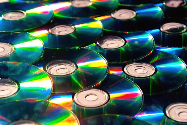 stock image A lot of shiny cd discs lie on each other and shine
