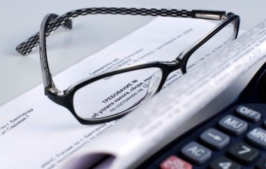 Tax document with calculator and glasses clipart