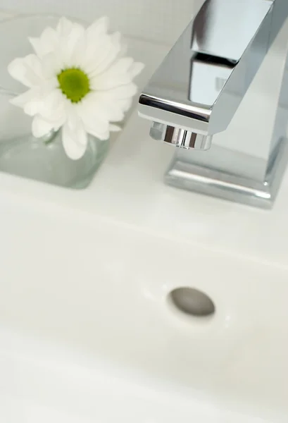 Chrome tap water and flower — Φωτογραφία Αρχείου