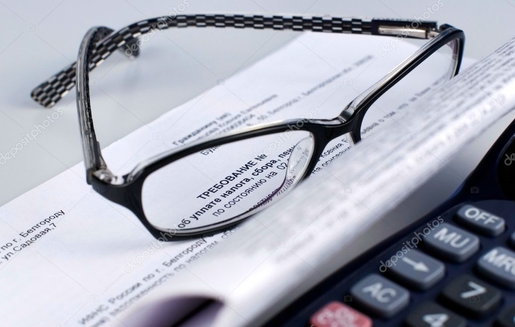 Tax document with calculator and glasses