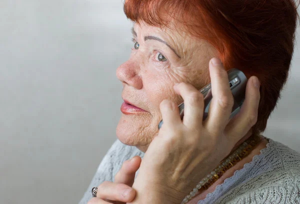 Семидесятирічна жінка з мобільним телефоном — стокове фото