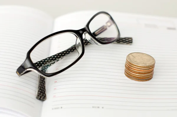 Business-Brille, Tagebuch und Münzen — Stockfoto