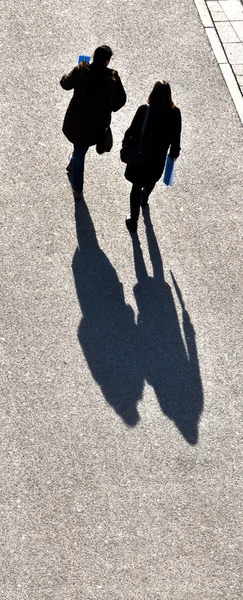 Walking at the street with long shadows — Stock Photo, Image