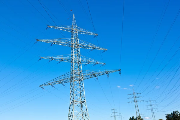 Steel electricity pylon on bright blue sky — Stock Photo, Image