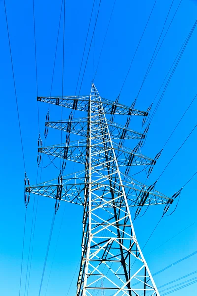 Сталевий електричний пілон на яскраво-синьому небі — стокове фото