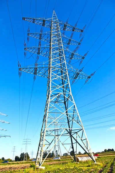 Steel electricity pylon on bright blue sky Royalty Free Stock Photos