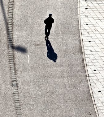 walking at the street with long shadows clipart