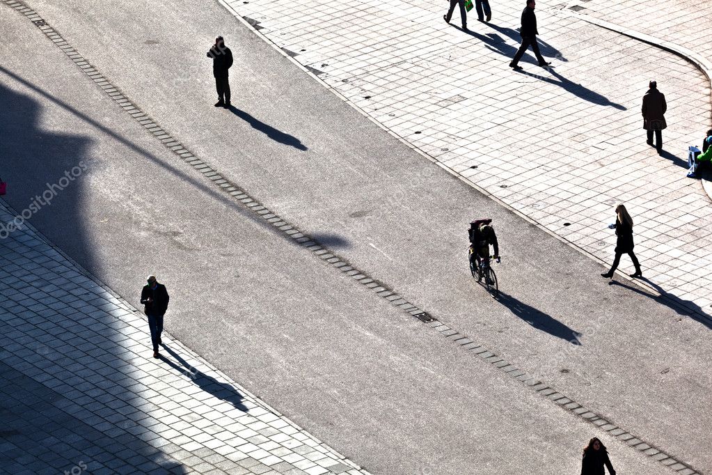 walking at the street with long shadows