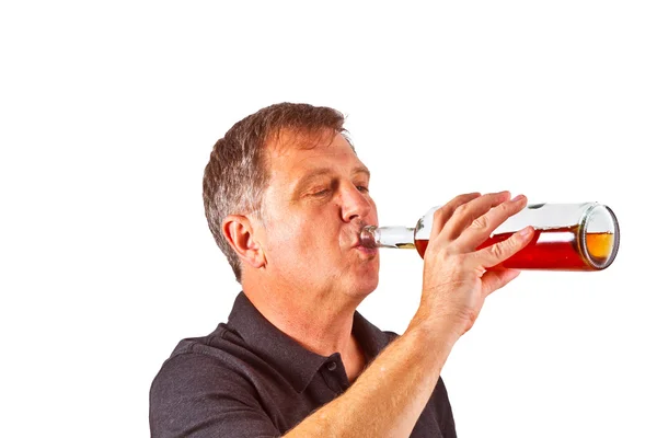 Человек, пьющий алкоголь из бутылки — стоковое фото