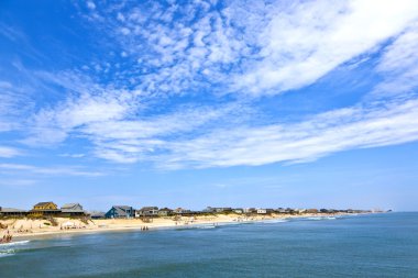 Beautiful beach with old cottages in Nags Head clipart