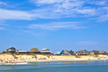 Beach with cottages at Nags Head in the outer banks clipart