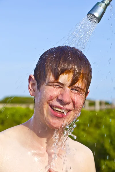 Boy has a shower at the beach — Stock Photo, Image