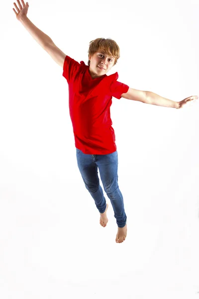 Chico inteligente con camisa roja saltando en el aire —  Fotos de Stock
