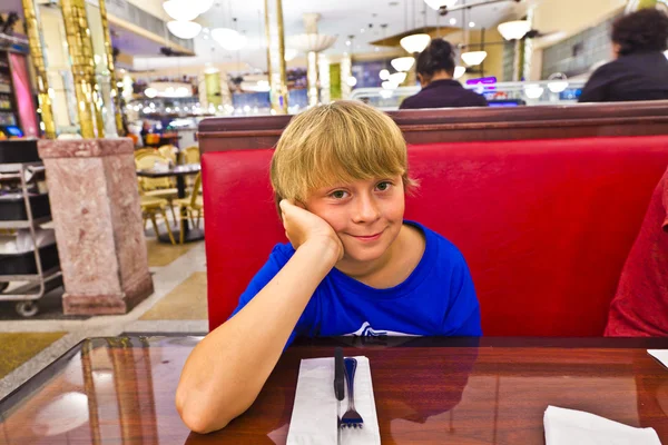 Smart boy in a diners at night — Stock Photo, Image