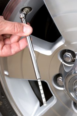 Checking tire pressure clipart