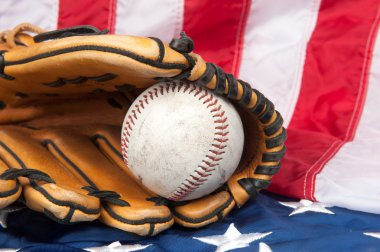 Baseball and glove on American flag clipart
