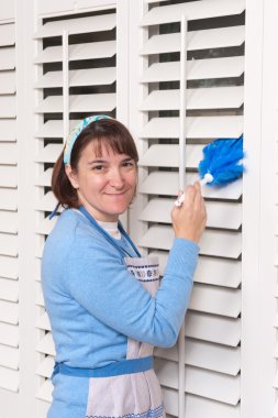 Woman cleaning shutters clipart