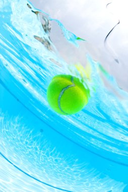 Tennis ball floating in swimming pool clipart