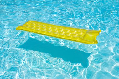 Yellow raft floating in a pool clipart