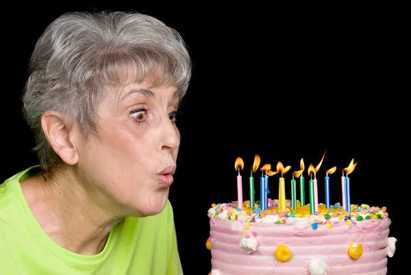 Adult blowing out candles — Stock Photo, Image