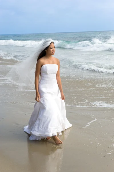 stock image Asian bride in wedding dress at beach