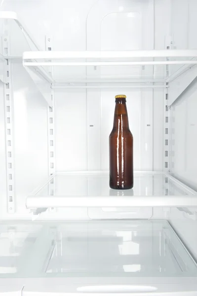 Bottle of beer in refrigerator — Stock Photo, Image