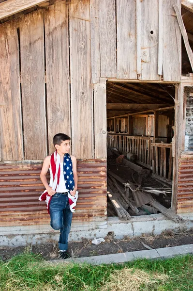 stock image Patriotic boy and old barn