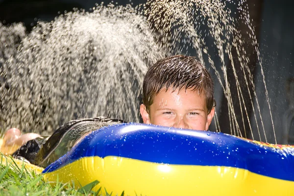 Kid on water slide — Stock Photo, Image