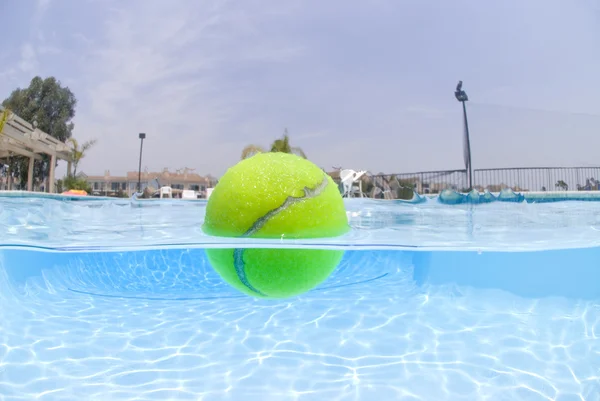 Tennis ball floating in pool — Stock Photo, Image