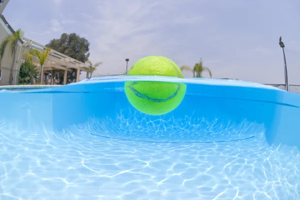 Tennis ball in pool — Stock Photo, Image