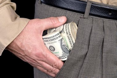 Man stuffing wads of cash into his pocket clipart