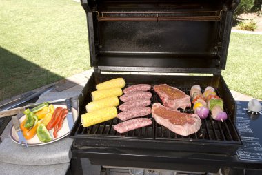 Barbecue with steaks, brats chicken and corn clipart