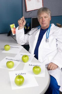 Doctor plans his healthy diet clipart