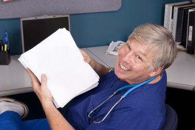 Doctor holding a large manuscript clipart